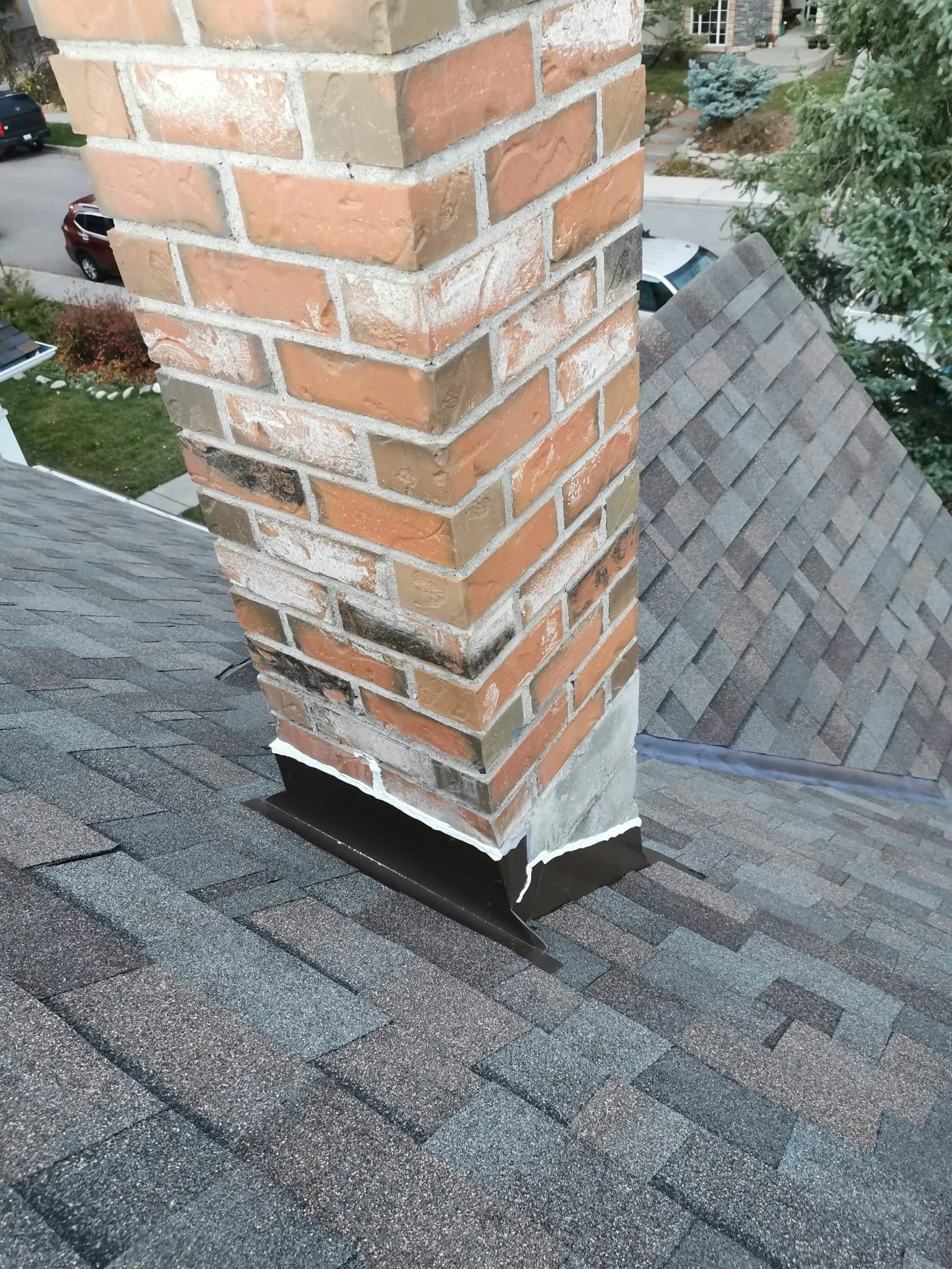 Chimney flashing rebuilt and reshingled on a Calgary roof