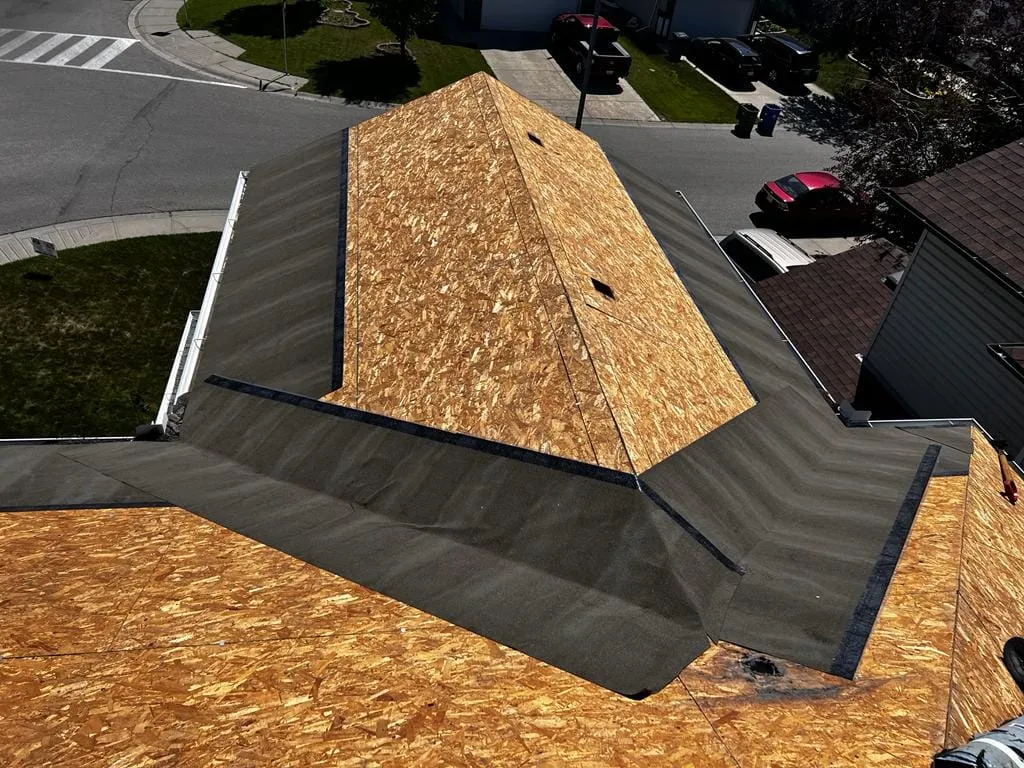 Plywood roof decking exposed at tear-off, where rotten sheathing turns up