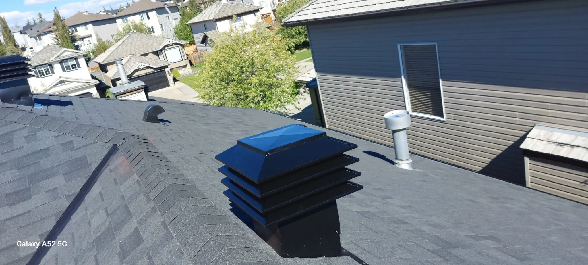 Roof vent installed through the shingles on the exhaust side
